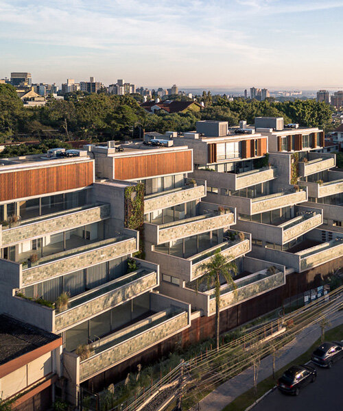 OSPA's residential facade unfolds stone-clad staggered pools and terraces in brazil