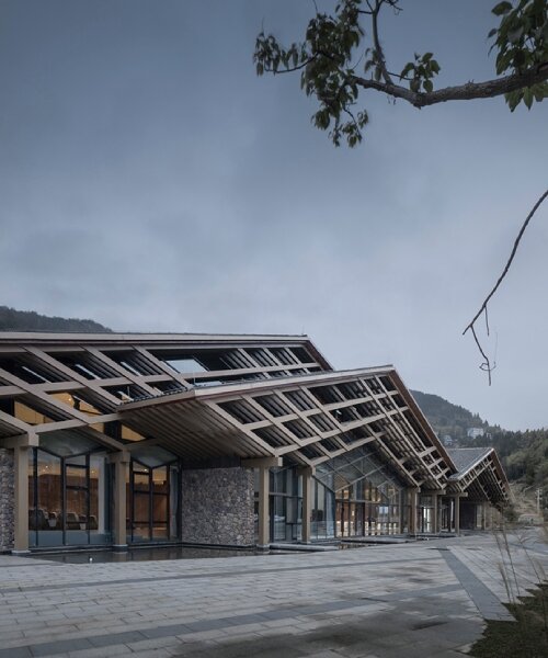 cascading folding roof of GLA design's community center in china echoes mountain contours